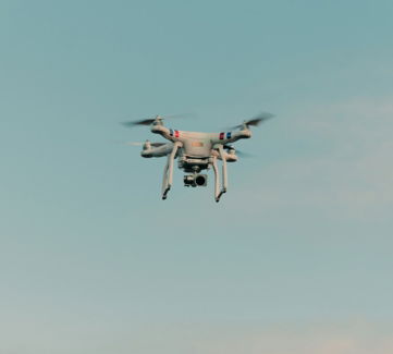 white-and-black-drone-flying-in-the-sky.jpg white and black drone flying in the sky